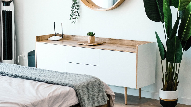bedroom with wooden credenza